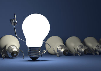 Glowing light bulb character in moment of insight.