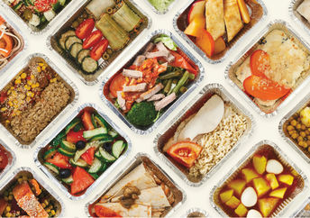 Restaurant food is wrapped in foil tins, ready for doggie bags.