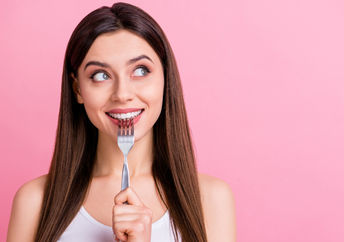 A young woman dreaming about food.