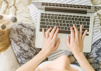 Typing on a laptop keyboard.
