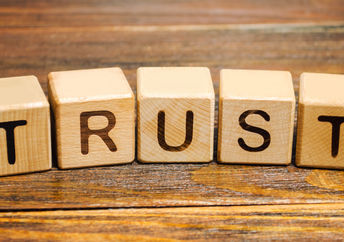 Wooden blocks with the word Trust.