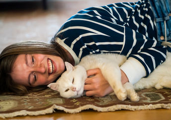 Girl relaxing to the sounds of a purring cat.