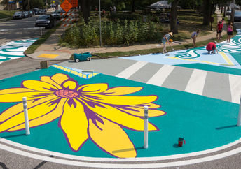 Artists and volunteers paint a colorful intersection in Pittsburgh, PA.