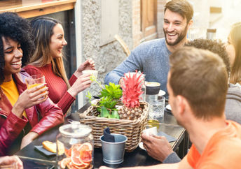 A group of friends enjoying a meal together at a restaurant.