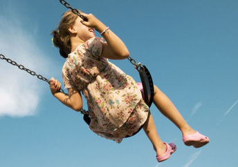 A woman enjoying a swing is a simple pleasure.