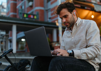 A young man typing on a computer.
