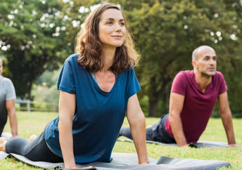 Yoga stretching in a park,