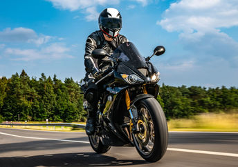 A motorcyclist wearing protective gear.