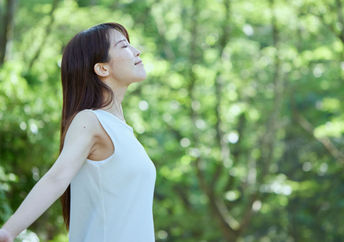 Japanese woman forest bathing.