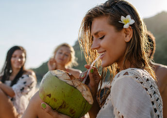 Drinking from a coconut.