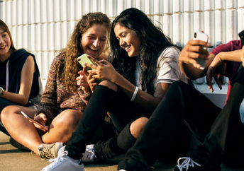 Students using digital devices.