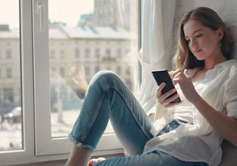 Young woman using a mental health app.