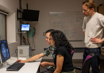 researchers looking at brain scans.