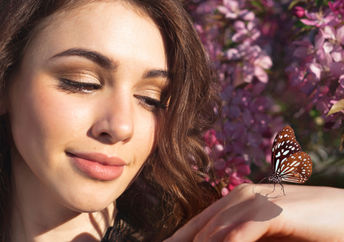 Woman holding a butterfly.
