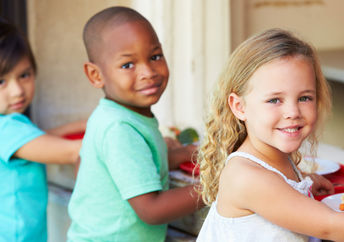 Elementary pupils collect healthy school lunches in the cafeteria.