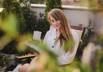 Woman surrounded by greenery.