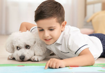 Little girl reading to her pet.