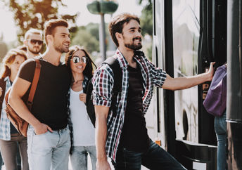 Passangers getting on a bus.