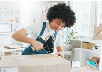 Woman using tape to seal a box.