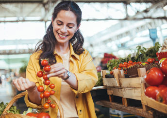 Buying tomatoes at a farmers market.
