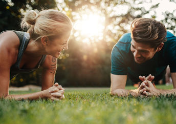 Couple exercising in their backyard.