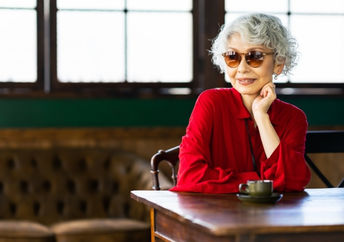 Senior Japanese woman relaxing in a restaurant.