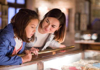 Mother and daughter exploring a museum.