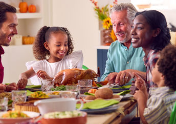 Family sharing a Thanksgiving meal.