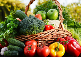 Wicker basket with assorted raw vegetables.