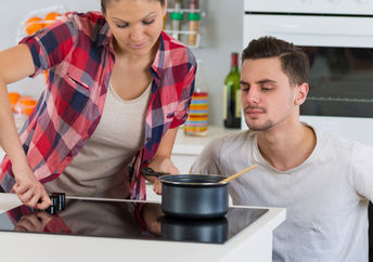 Young woman cooking with her boyfriend.