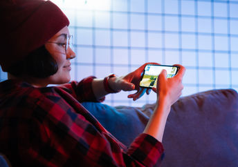 Playing  game on a cellphone.