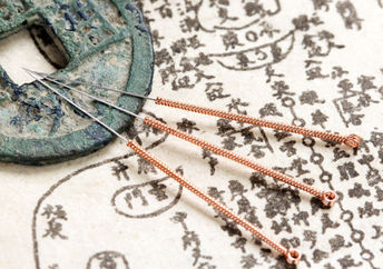 Acupuncture needles and text.