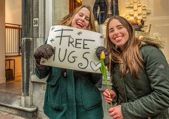 Give hugs to random people.