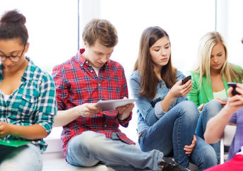 Students using smart devices.
