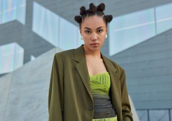 Stylish Millennial poses outdoors.