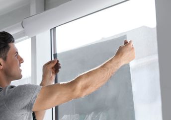 Installing window film to keep the heat out.