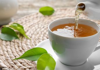 Pouring a cup of green tea.