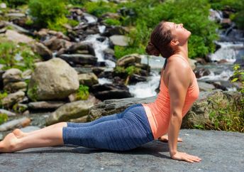 Woman doing the sun salutation sequence of poses.