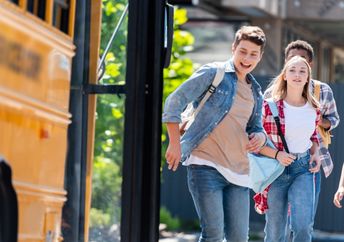 Teens riding the school bus home,