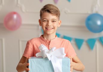 Cute boy bearing a gift.