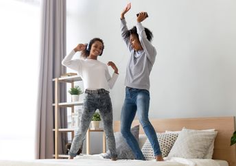 Mother and daughter dancing to golden oldies.
