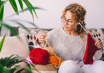 Woman knitting on a cold winter day..