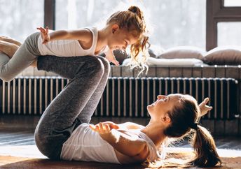 Mother and daughter doing yoga.
