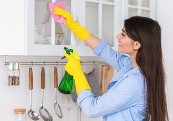 Woman spring cleaning her home.
