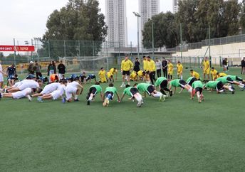 Youth from diverse backgrounds and cultures in Israel play soccer.