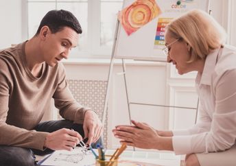 A young man in an art therapy session.