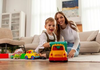 A kid plays with a toy car.