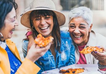 Group of older women enjoying eating together.