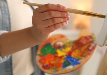 An artist painting a canvas.