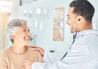 Cardiologist listening to a senior patient’s heart.